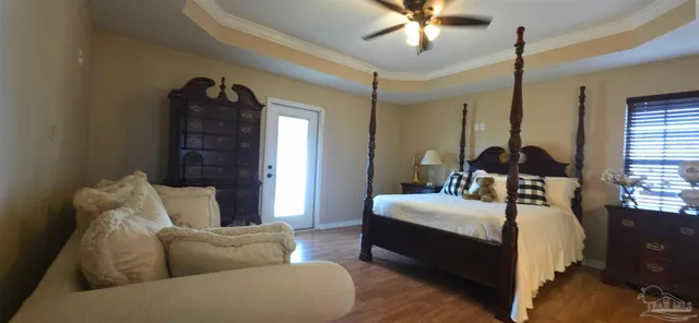 a bedroom with a bed window and couch