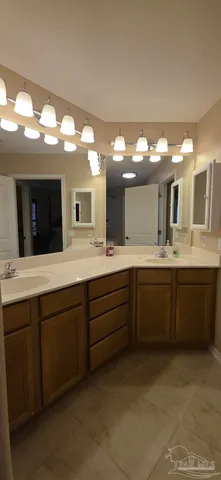 a bathroom with a double vanity sink and a mirror