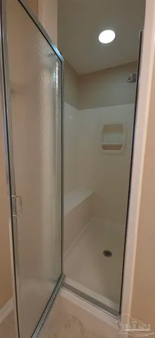 a bathroom with a glass shower door