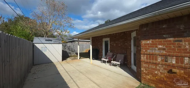 a view of a chair and tables in patio of the house