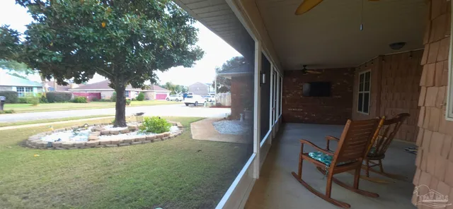 a backyard of a house with a table and chairs