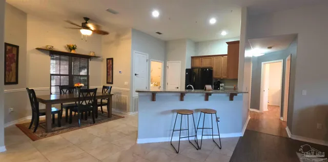 a view of a a dining room with furniture window and wooden floor