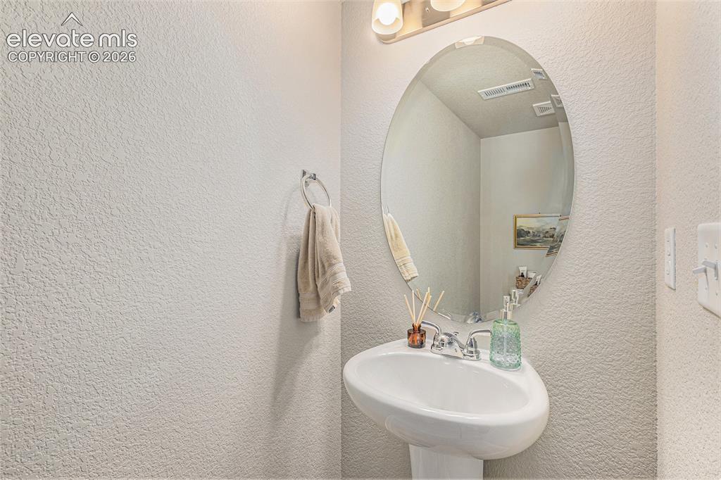 2940 Magic Carpet Loop Colorado Springs, CO 80916 - Photo 11 of 21 a bathroom with a sink and a mirror