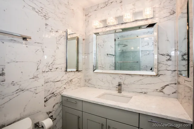 a white toilet sitting next to a bath tub and a shower