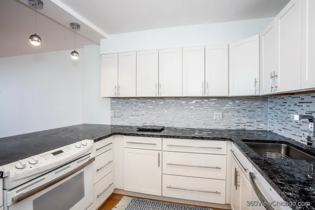 a view of white cabinets and sink