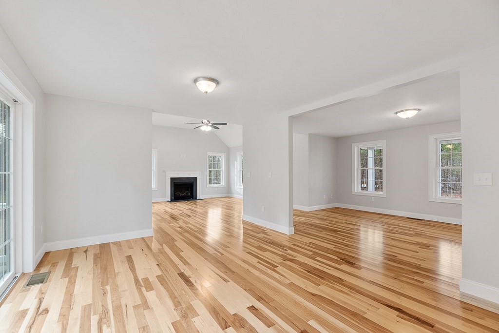 207 Worcester Road Princeton, MA 01541 - Photo 10 of 26 a view of empty room with wooden floor and fireplace