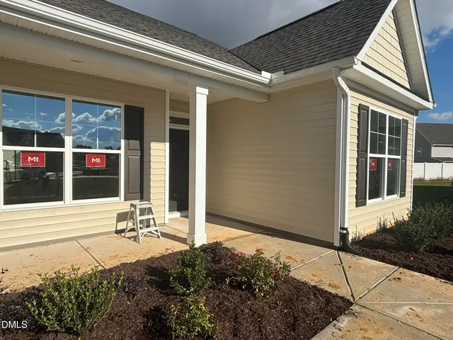 a view of a porch with a table and chairs