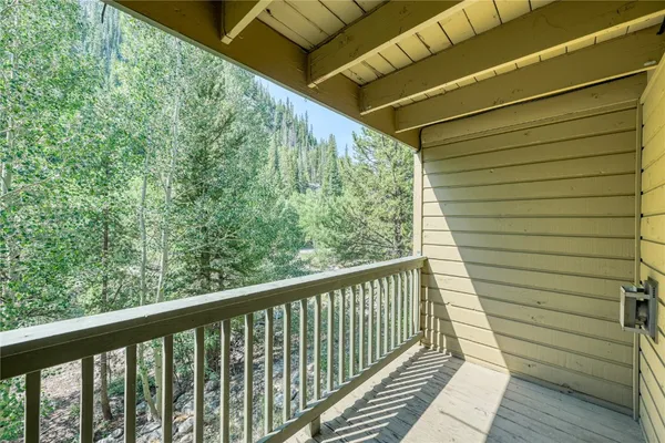 a view of a balcony with wooden floor