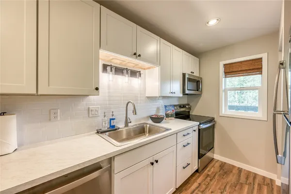 a kitchen with sink cabinets and window