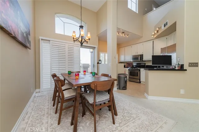 a kitchen with granite countertop white cabinets stainless steel appliances and a sink