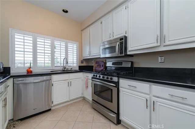 a kitchen with double sink and a window