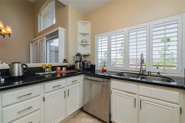 a kitchen with cabinets stainless steel appliances and sink