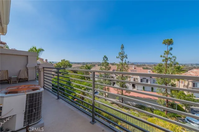 a room with painting on the wall and a potted plant