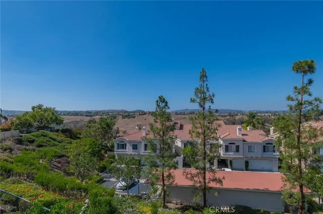 a view of a chairs and table in front of a house