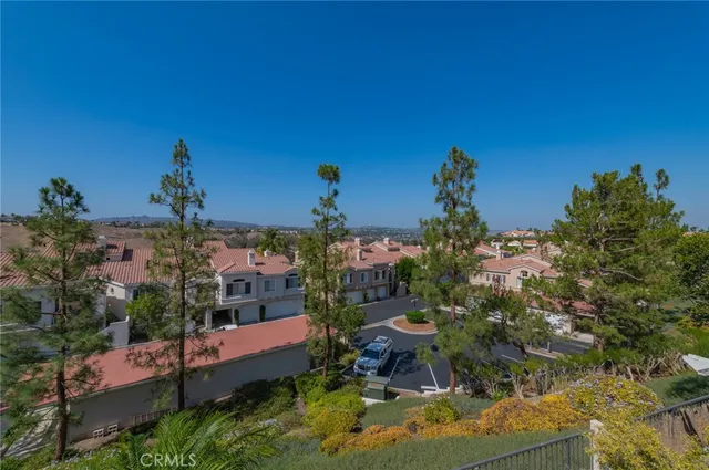 an aerial view of a house with a street