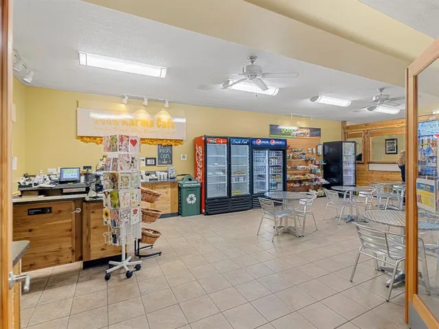 a view of a kitchen with dining table and chairs