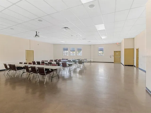 a view of a dining hall with furniture