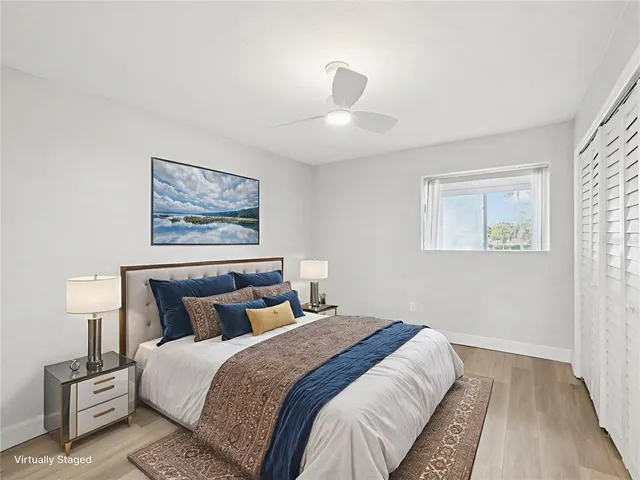 a bedroom with bed and night stand