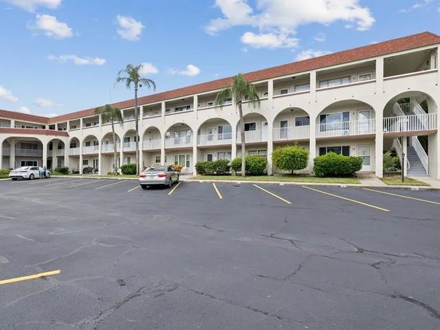 a front view of building with streets and trees