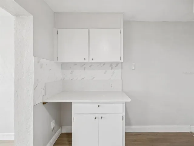 a view of cabinets and wooden floor