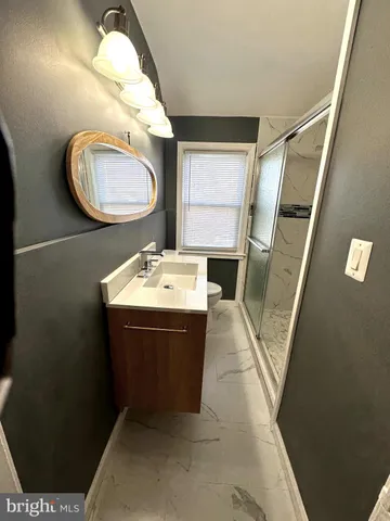 a bathroom with a sink mirror vanity and toilet
