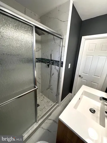 a bathroom with a shower and a sink