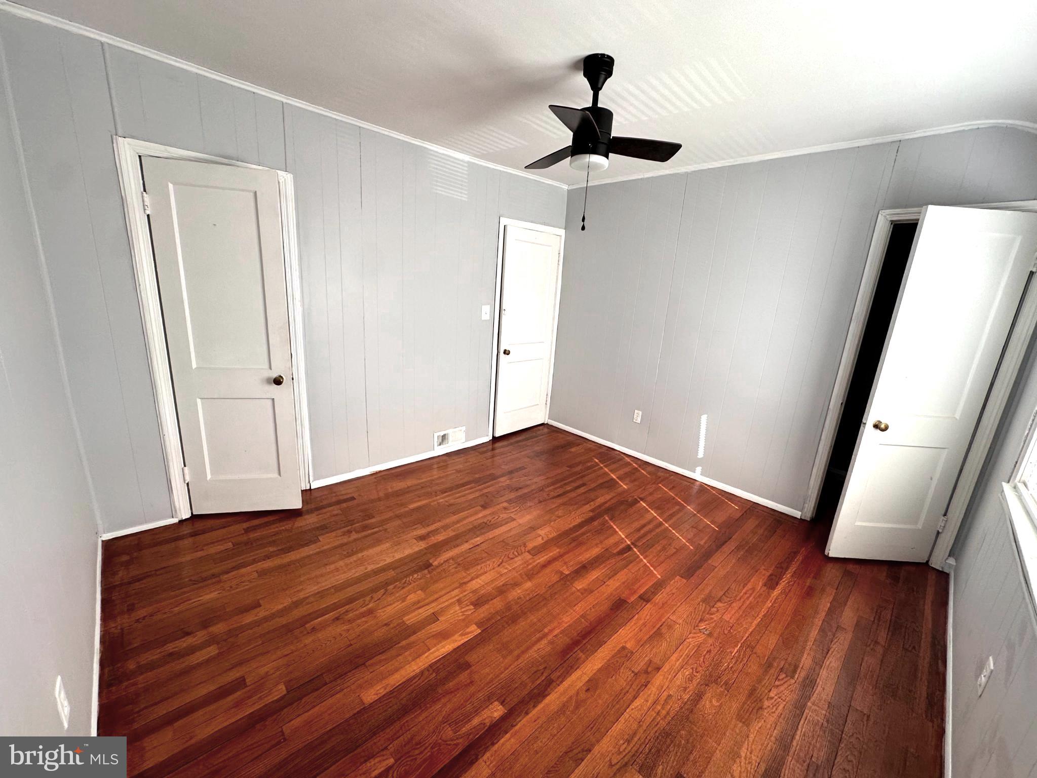 1008 Tunbridge Road Baltimore, MD 21212 - Photo 18 of 19 a view of empty room with wooden floor and fan