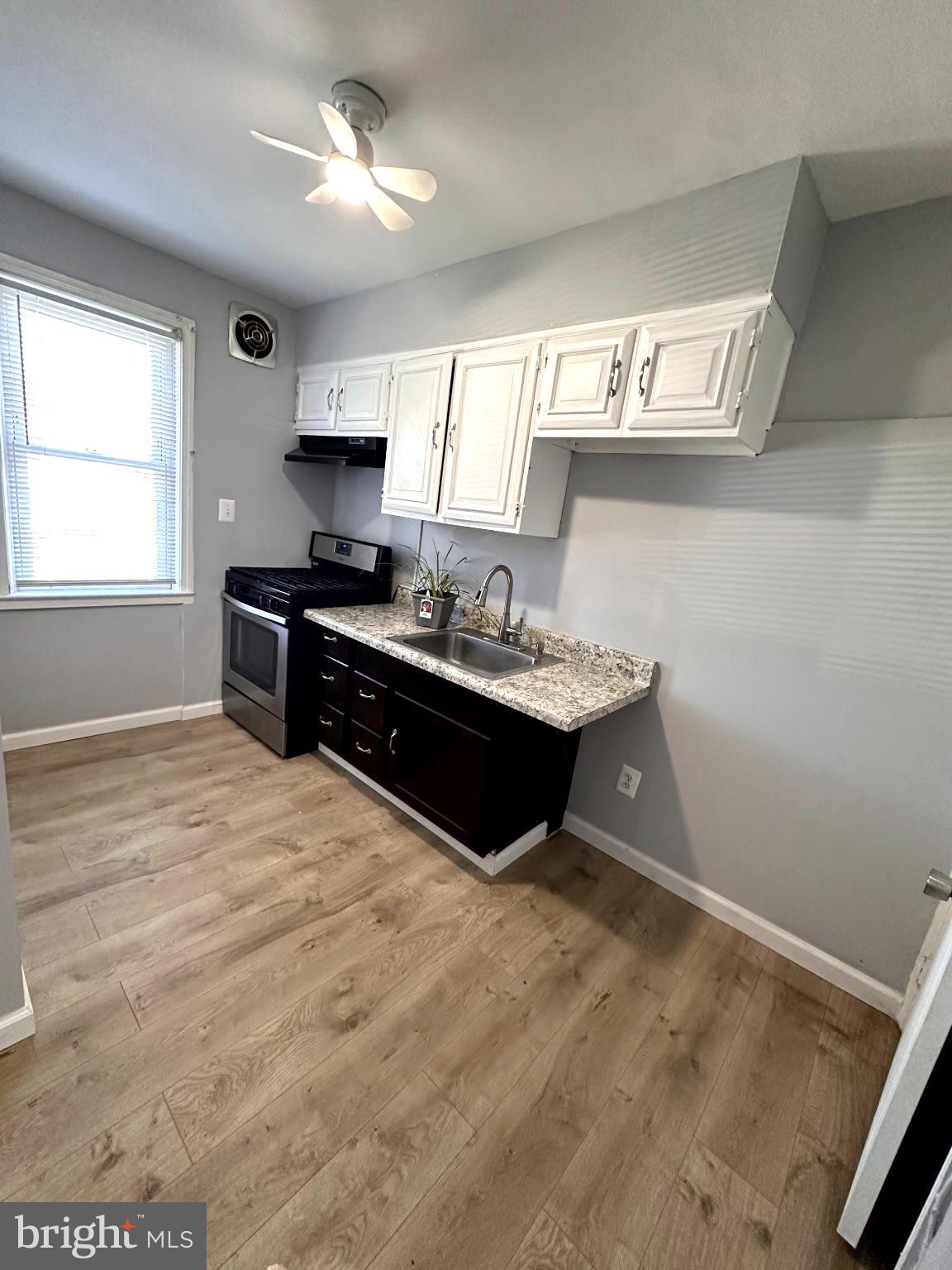 1008 Tunbridge Road Baltimore, MD 21212 - Photo 5 of 19 a kitchen with a stove sink and cabinets