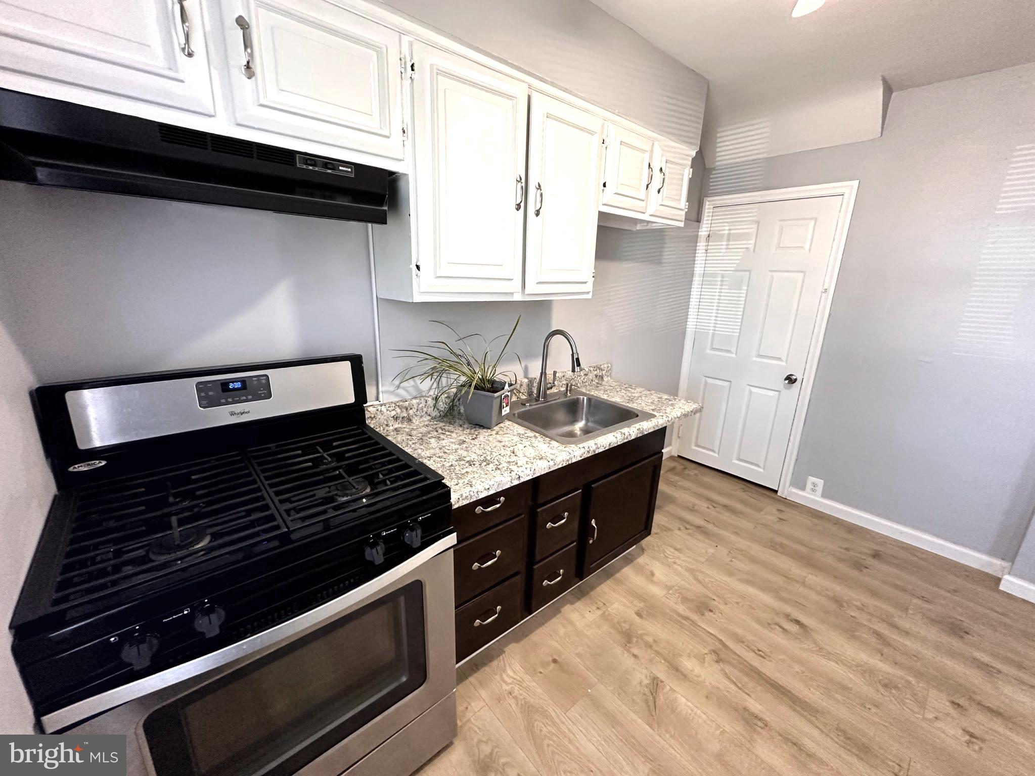 1008 Tunbridge Road Baltimore, MD 21212 - Photo 6 of 19 a kitchen with a stove and a microwave