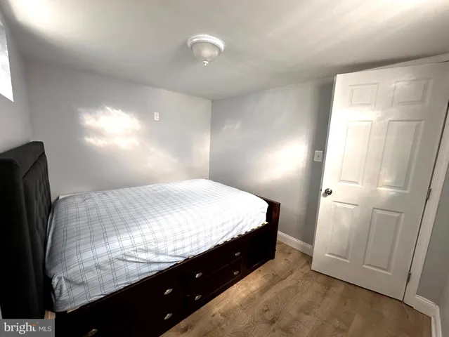 a bed sitting in a bedroom next to a window