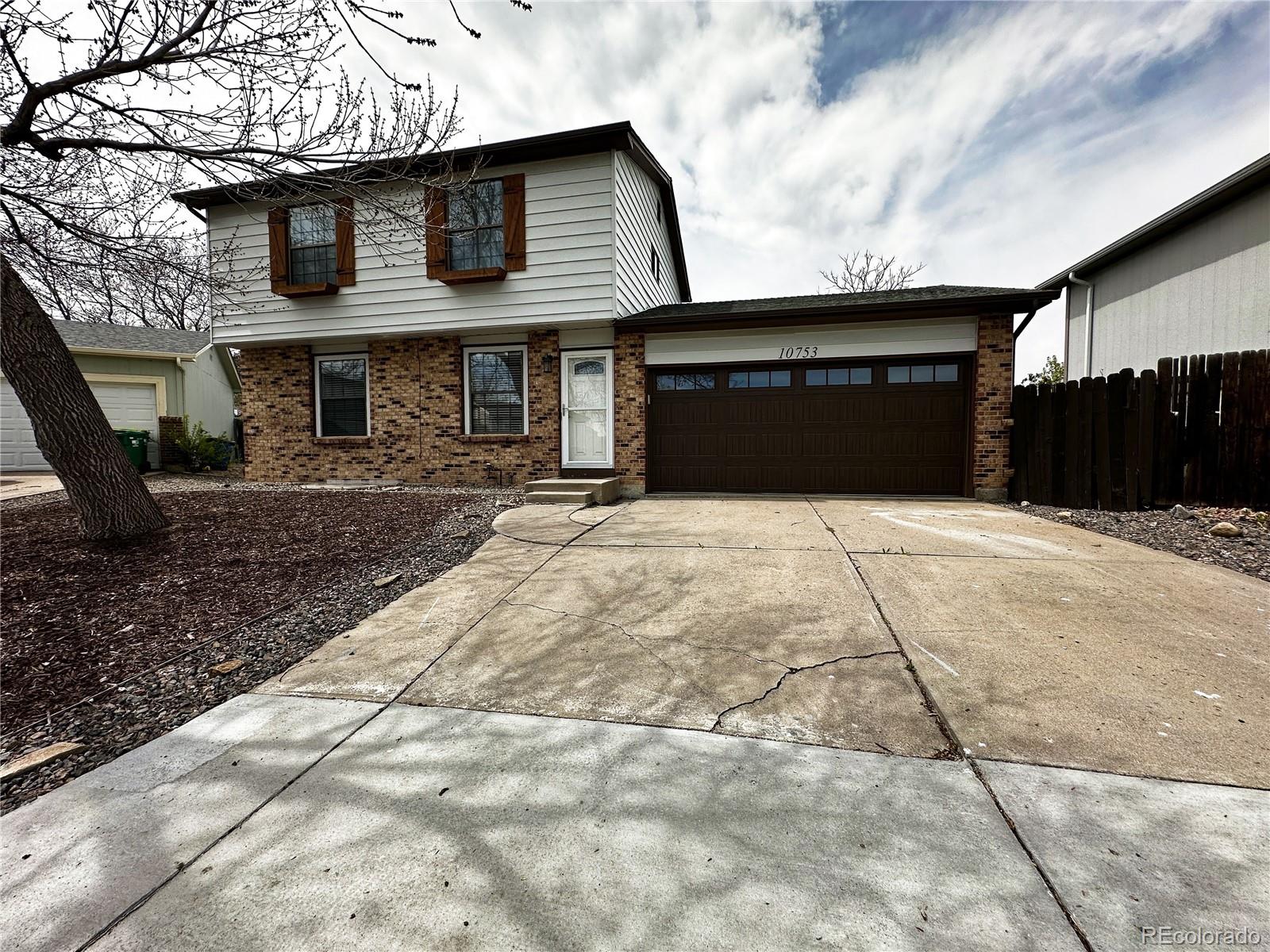 10753 Routt Court Broomfield, CO 80021 - Photo 1 of 24 a front view of a house with a yard