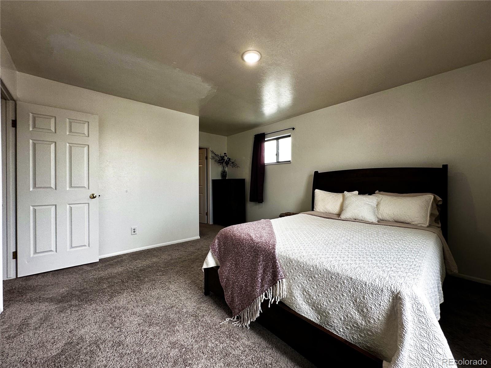 10753 Routt Court Broomfield, CO 80021 - Photo 11 of 24 a bedroom with a bed and a night stand