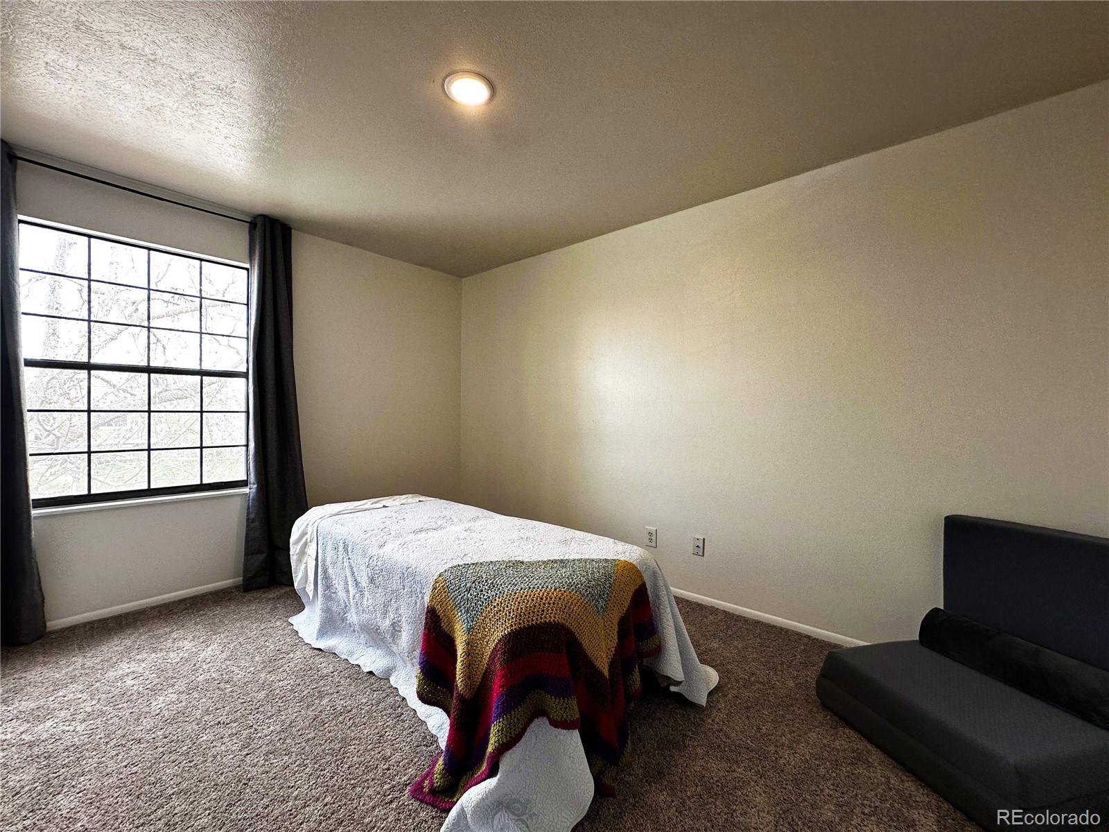 10753 Routt Court Broomfield, CO 80021 - Photo 14 of 24 a bedroom with a bed and window