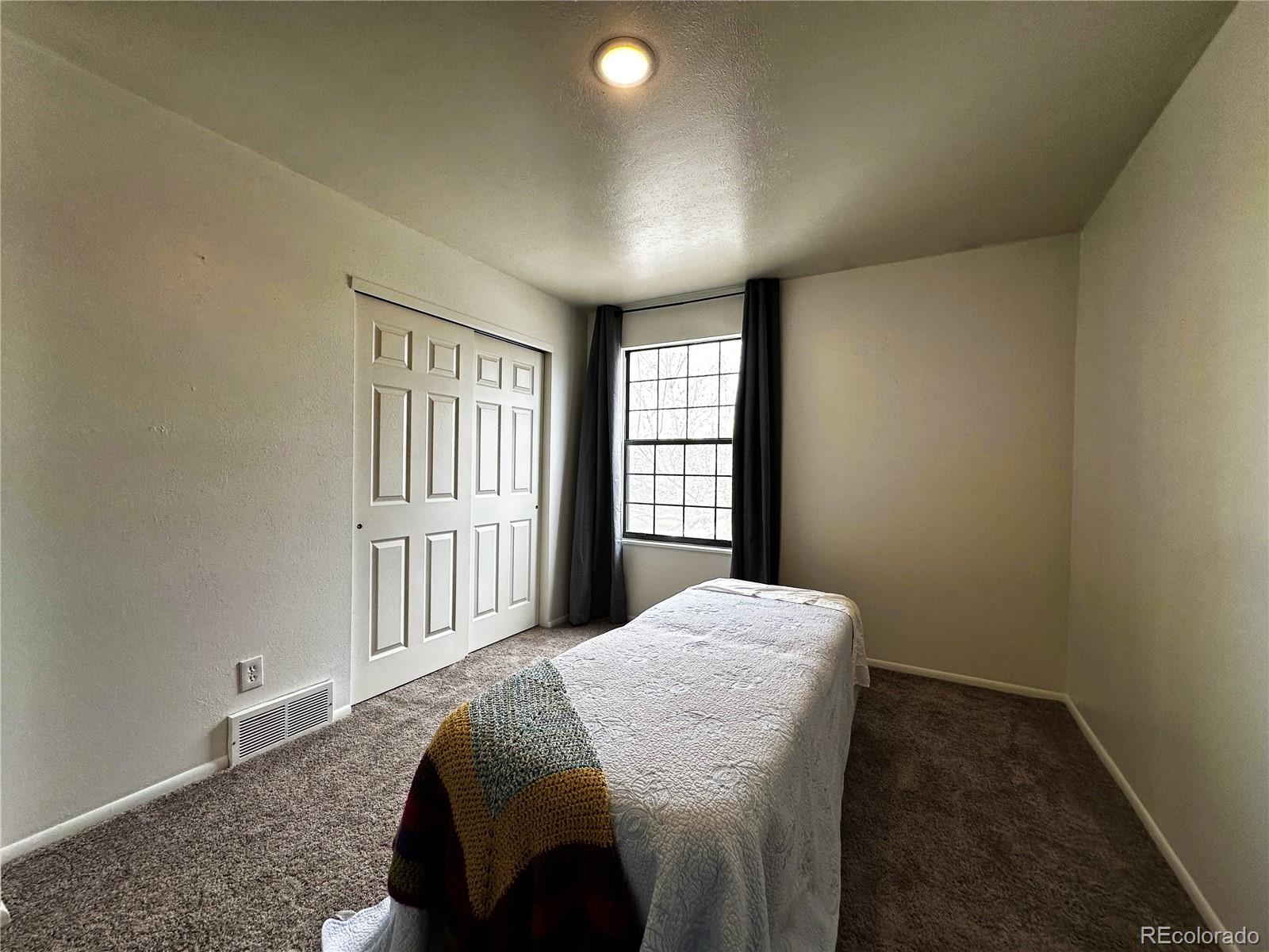 10753 Routt Court Broomfield, CO 80021 - Photo 15 of 24 a bedroom with a bed and a window