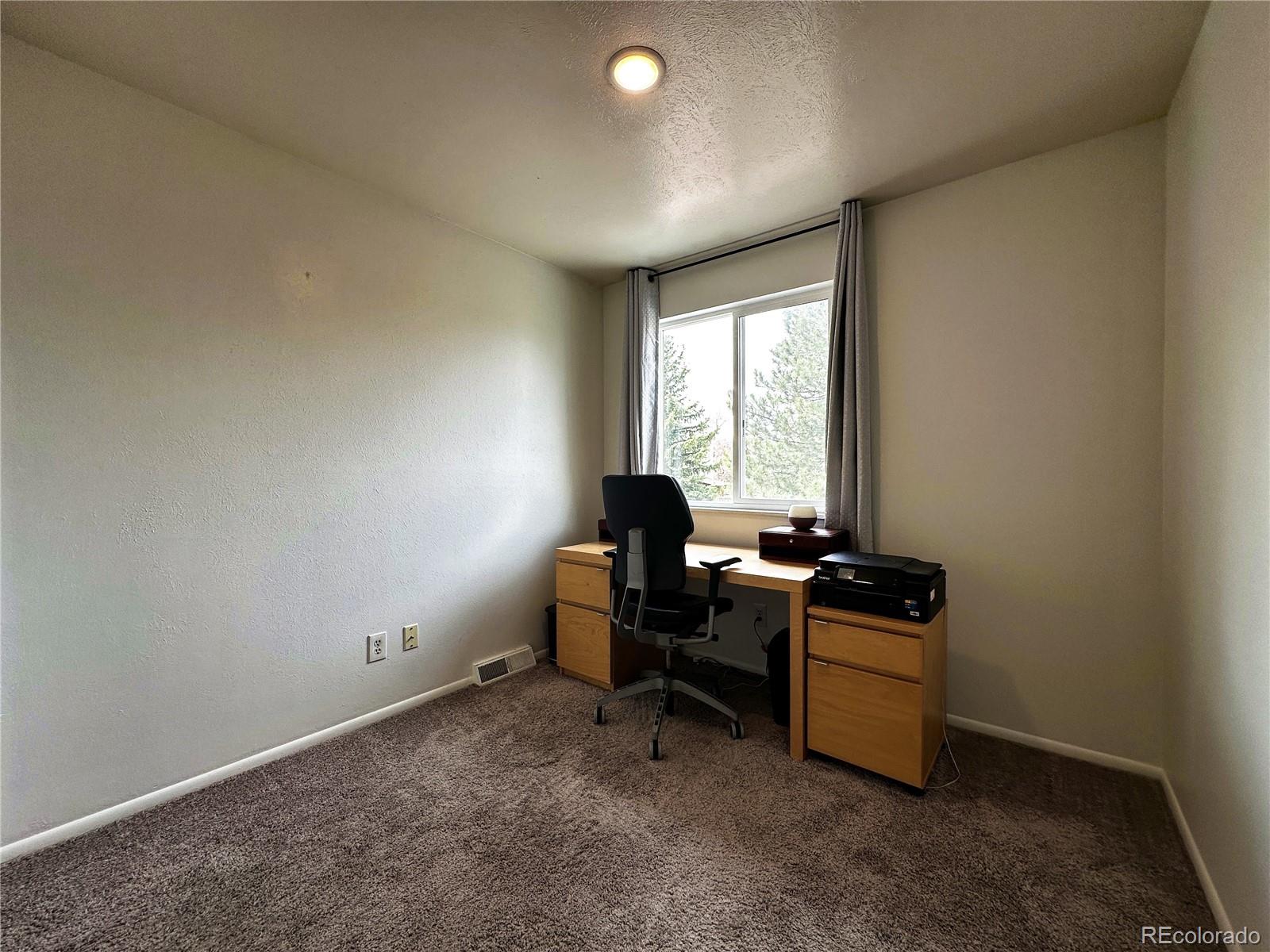 10753 Routt Court Broomfield, CO 80021 - Photo 16 of 24 a view of a workspace with furniture and a window