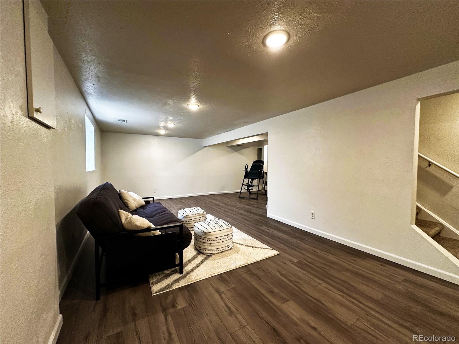 10753 Routt Court Broomfield, CO 80021 - Photo 18 of 24 a living room with furniture and wooden floor