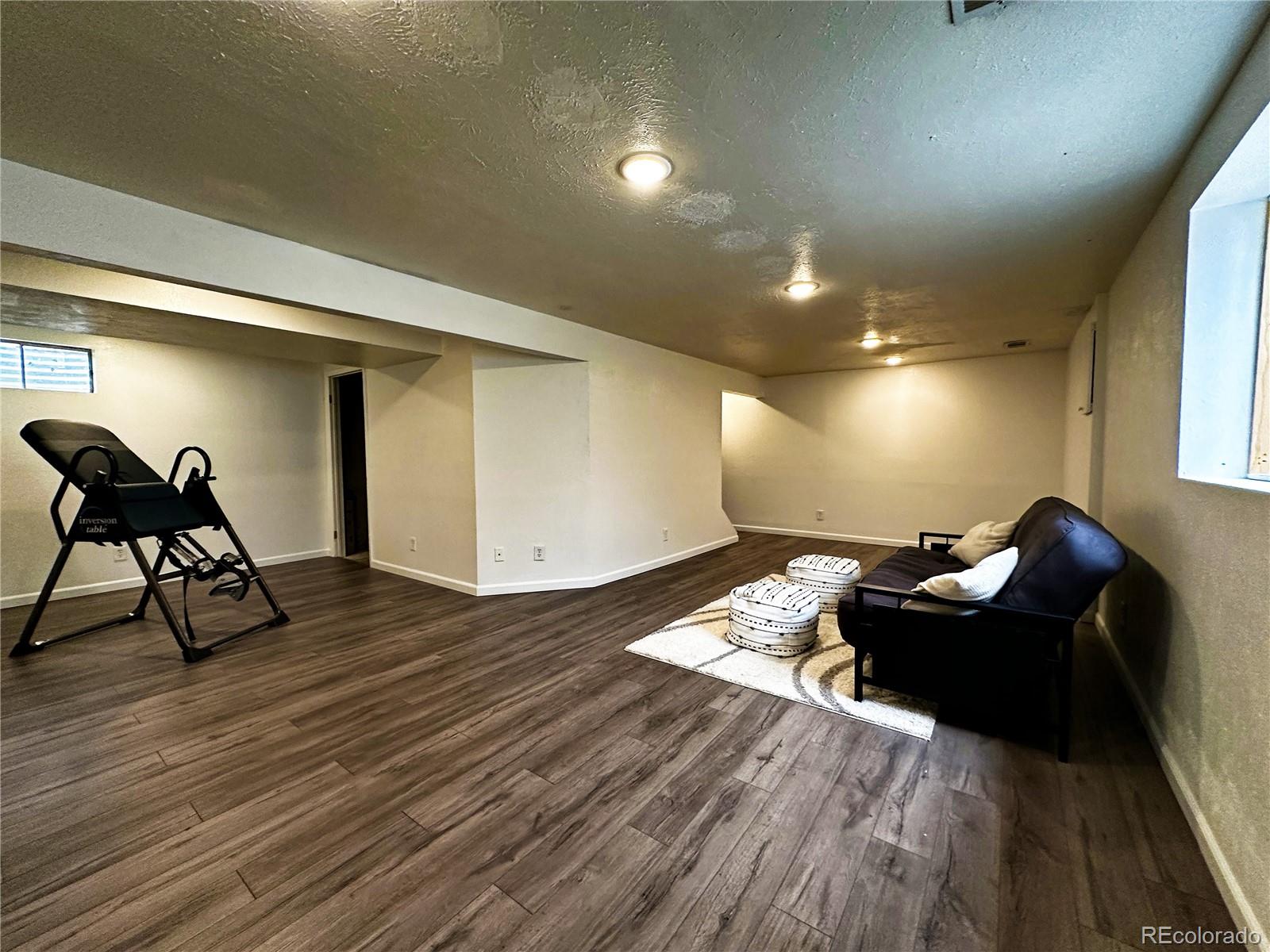 10753 Routt Court Broomfield, CO 80021 - Photo 19 of 24 a room with furniture and a wooden floor