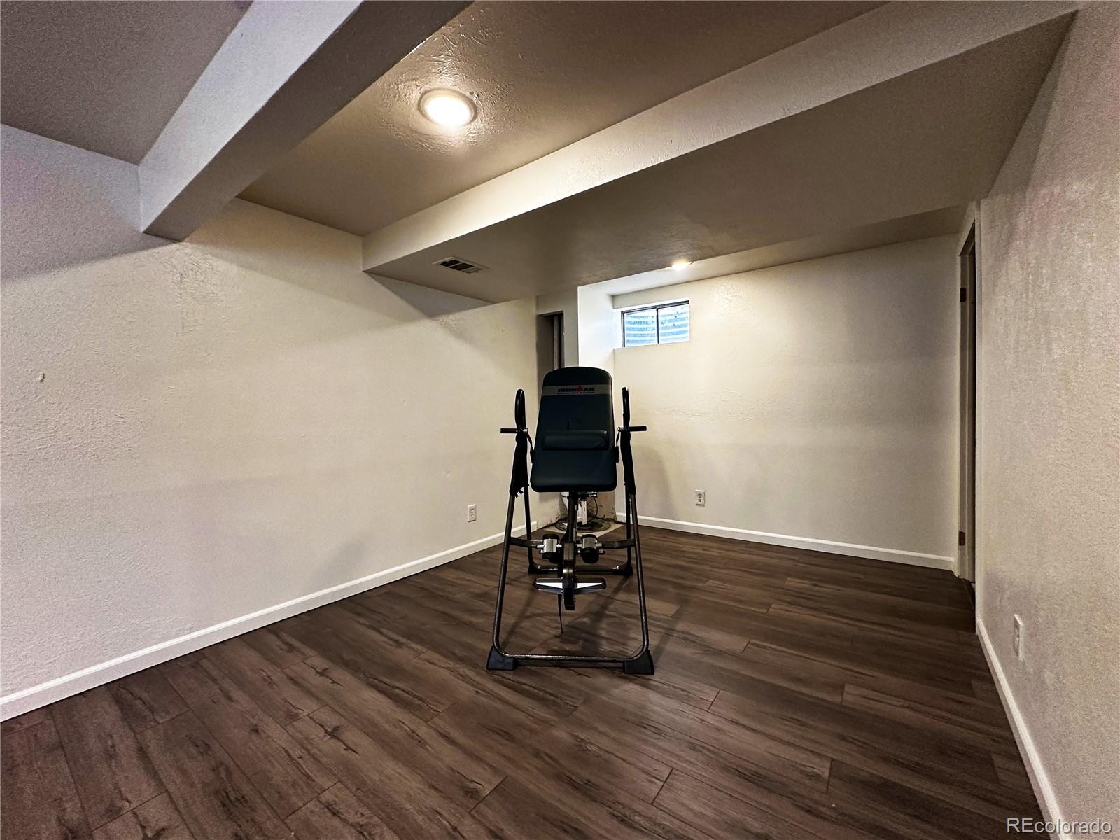10753 Routt Court Broomfield, CO 80021 - Photo 20 of 24 a view of a room with wooden floor table and chairs