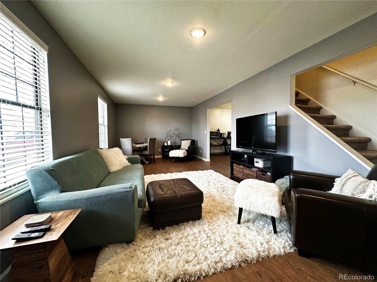 10753 Routt Court Broomfield, CO 80021 - Photo 3 of 24 a living room with furniture and a flat screen tv