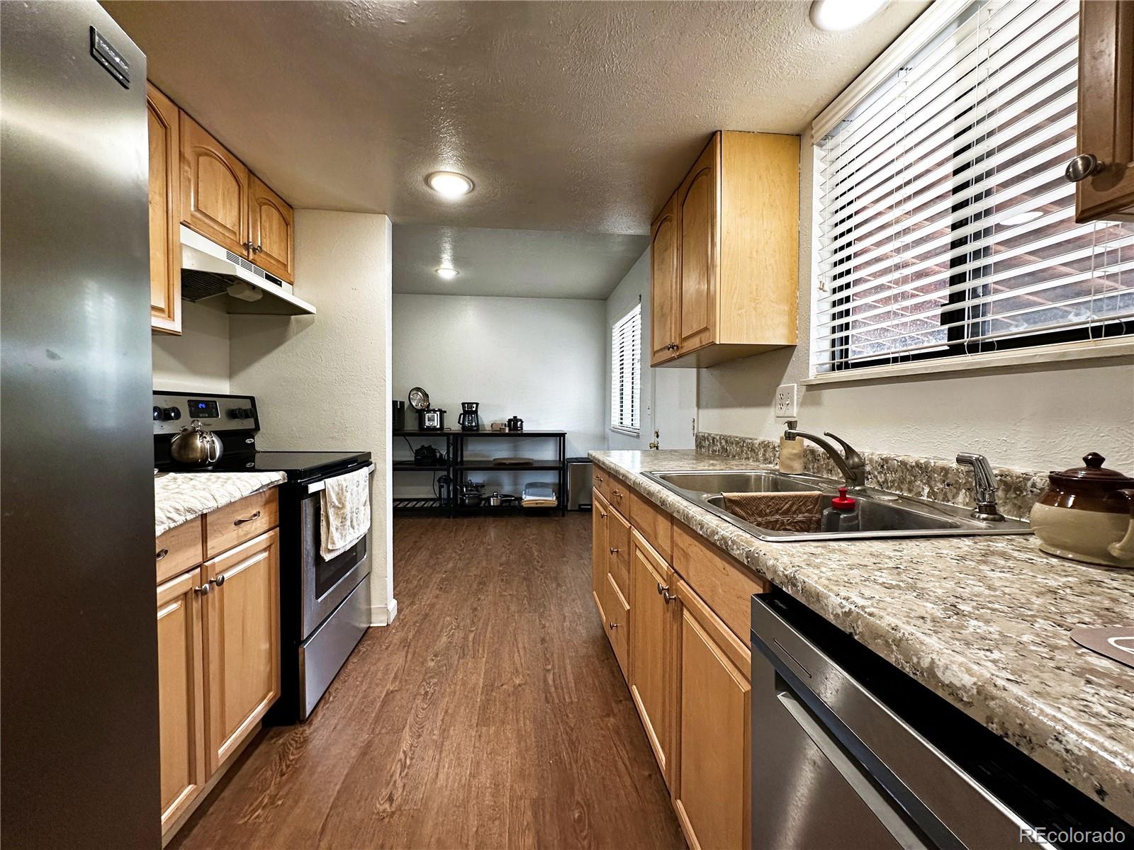 10753 Routt Court Broomfield, CO 80021 - Photo 6 of 24 a kitchen with a stove and a sink
