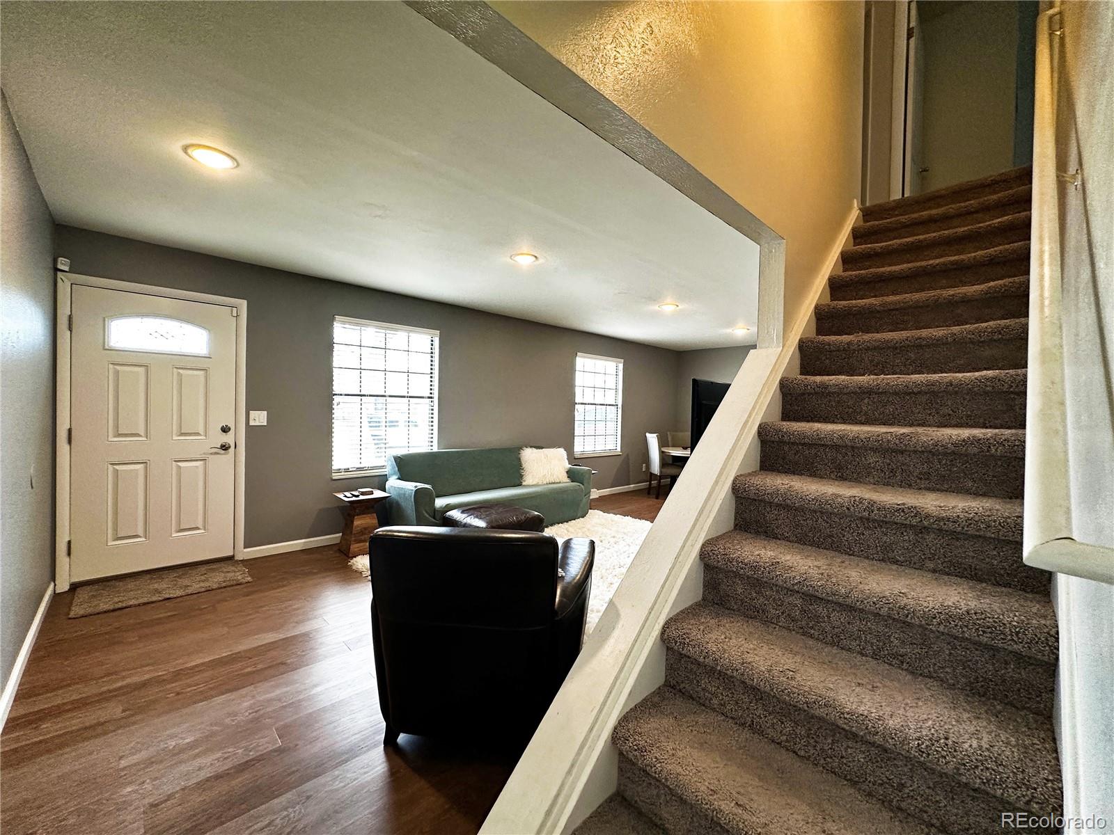 10753 Routt Court Broomfield, CO 80021 - Photo 9 of 24 a living room with furniture windows and wooden floor