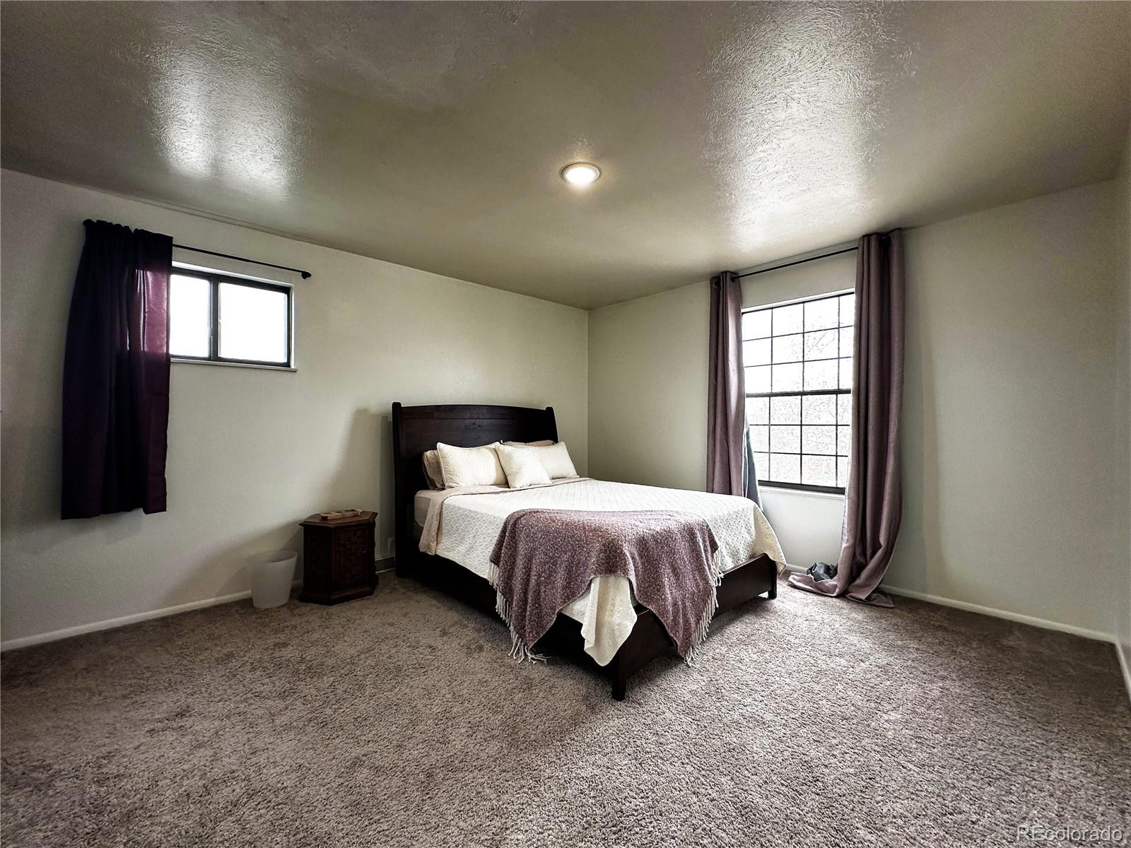 10753 Routt Court Broomfield, CO 80021 - Photo 10 of 24 a spacious bedroom with a bed and a window