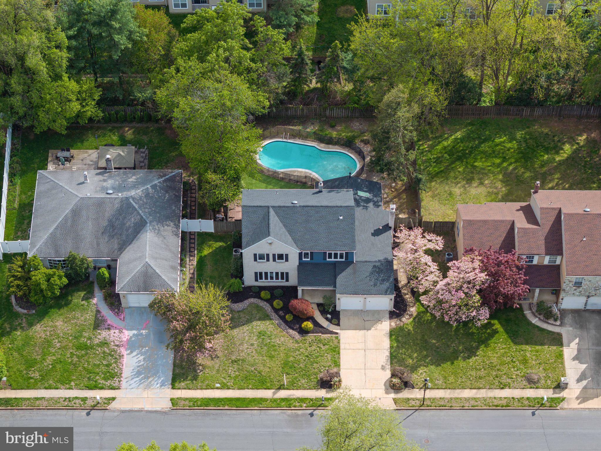 an aerial view of a house with a yard and garden