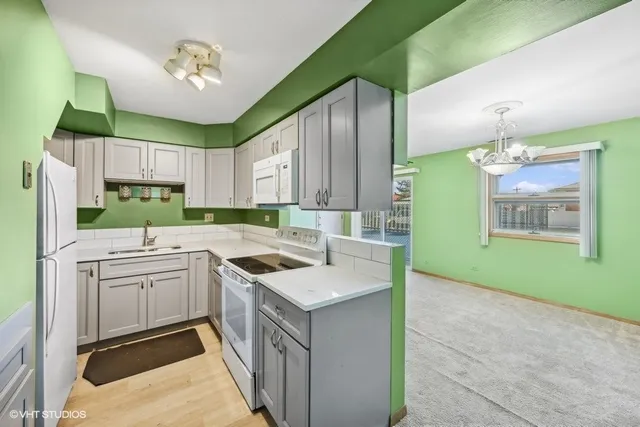 a kitchen with cabinets a sink and appliances