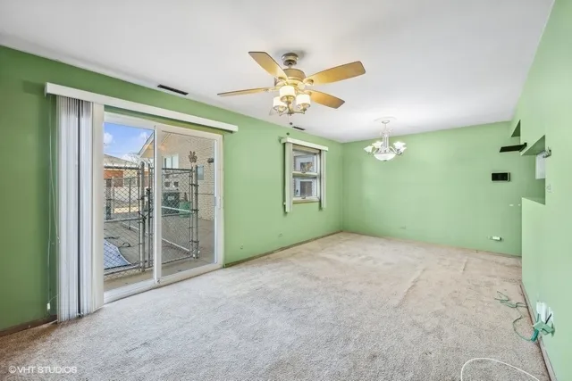 a view of a livingroom with a ceiling fan and window