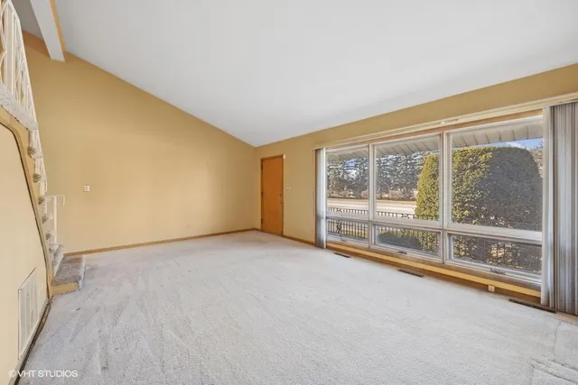 a view of an empty room with a window