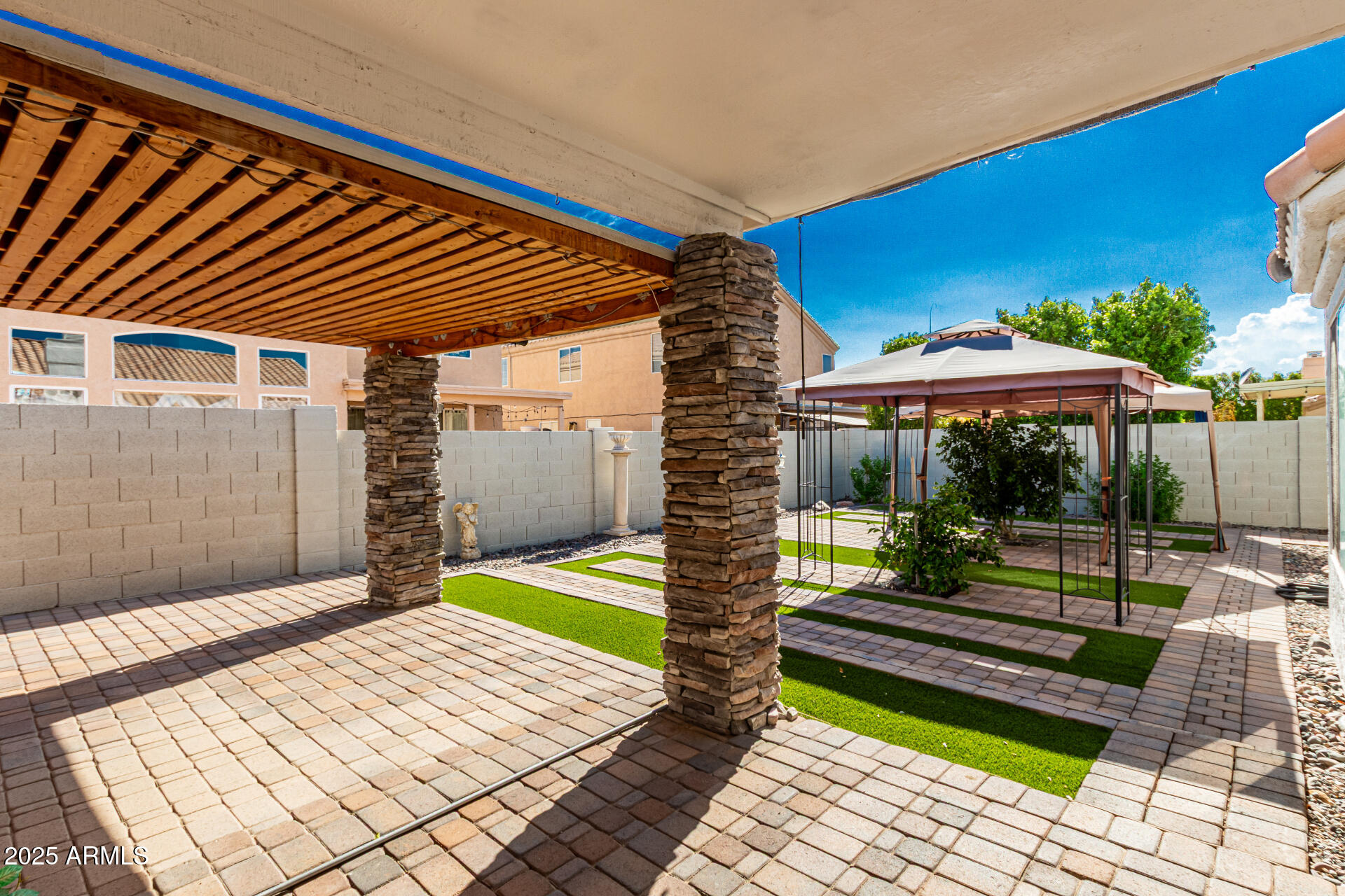 217 West Smoke Tree Road Gilbert, AZ 85233 - Photo 26 of 48 a backyard of a house with barbeque oven table and chairs