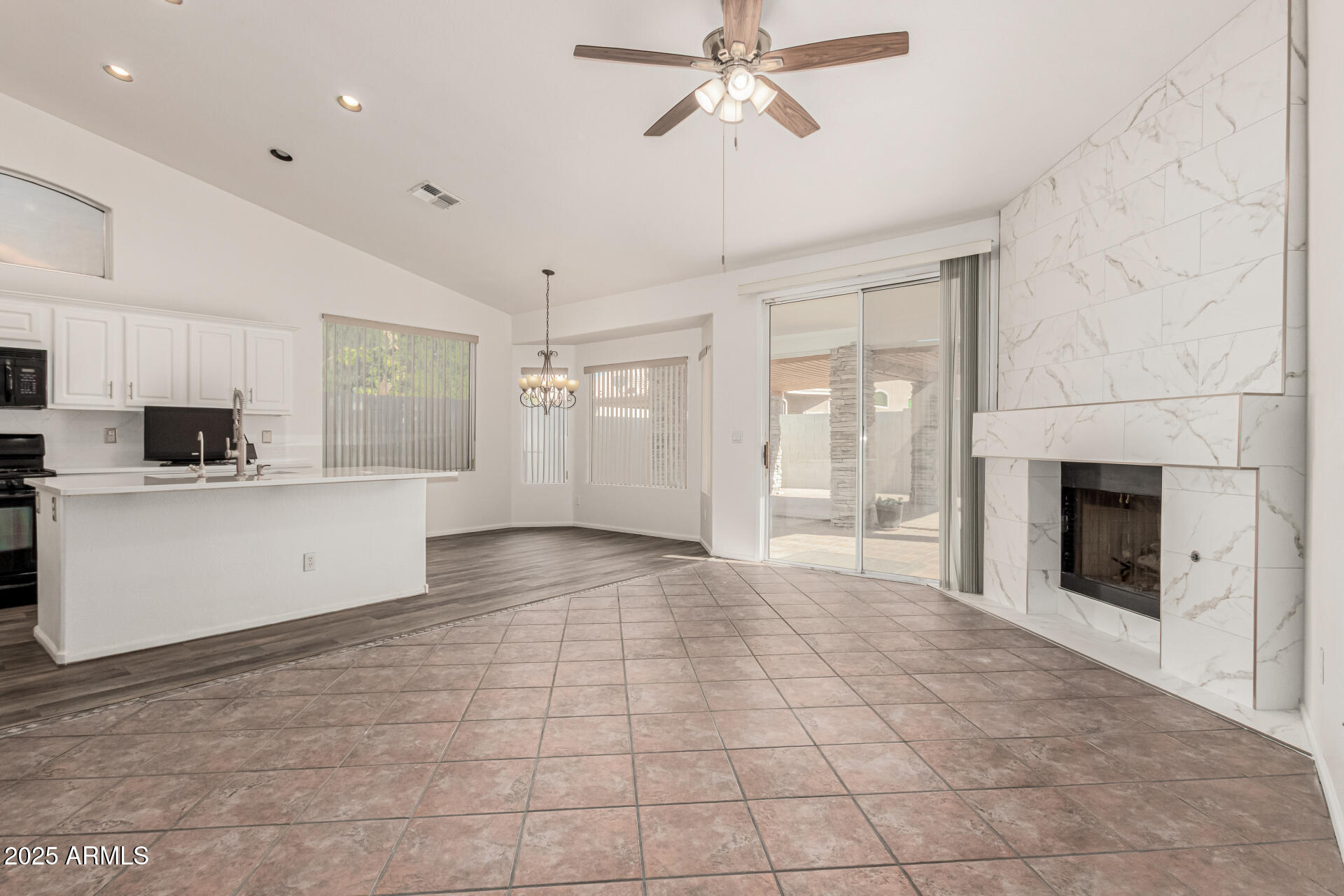 217 West Smoke Tree Road Gilbert, AZ 85233 - Photo 7 of 48 a view of a kitchen with an empty space and a fireplace