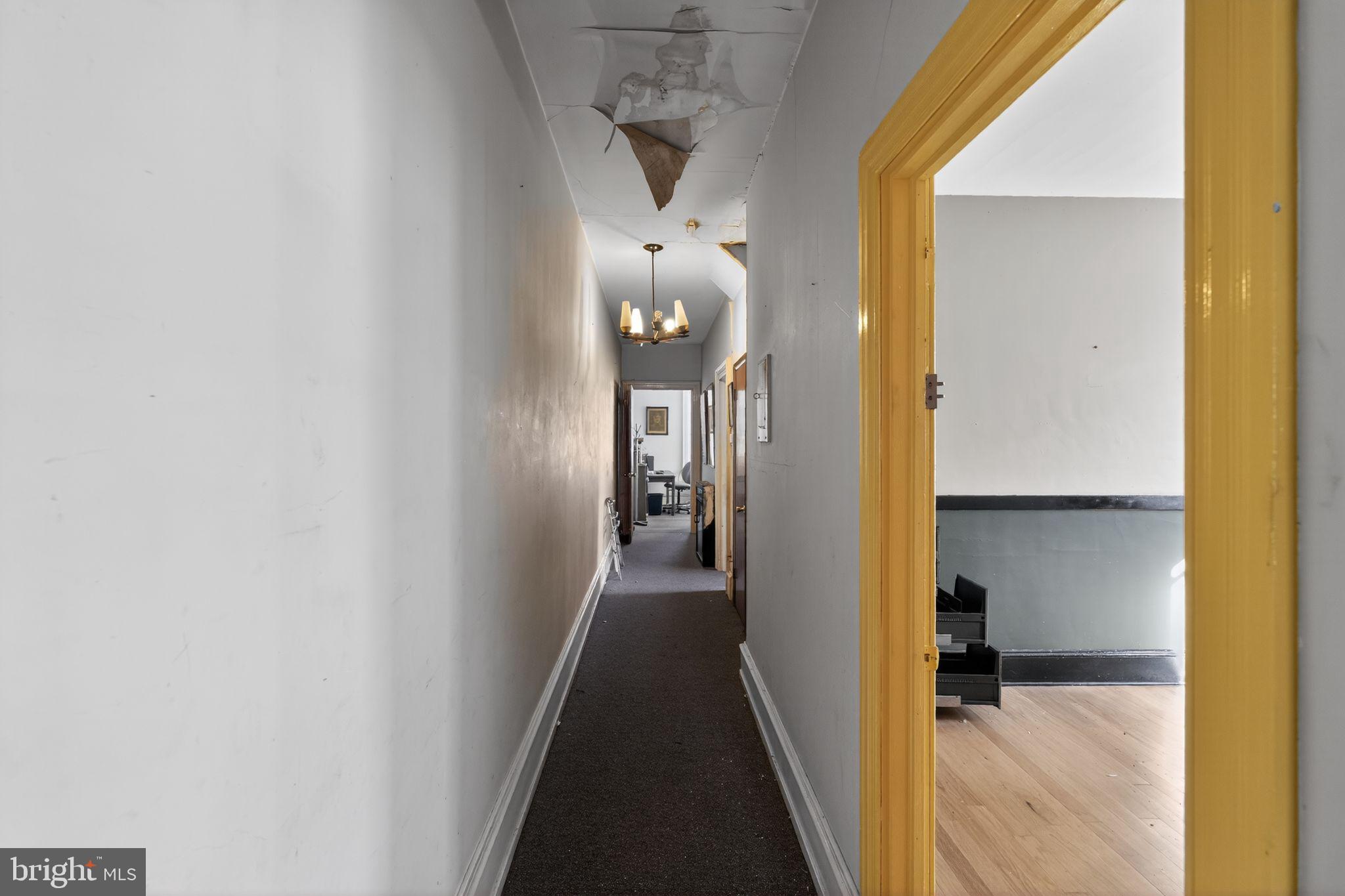6600 Ridge Avenue Philadelphia, PA 19128 - Photo 31 of 47 a view of a hallway with wooden floor and a bathroom