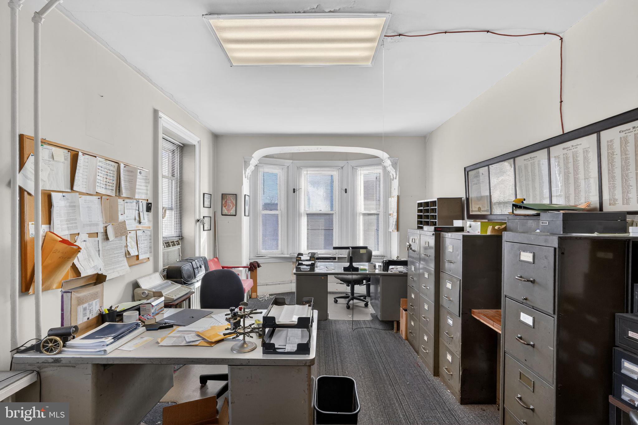 6600 Ridge Avenue Philadelphia, PA 19128 - Photo 37 of 47 a kitchen with stainless steel appliances a refrigerator a stove a sink and a dining table with wooden floor